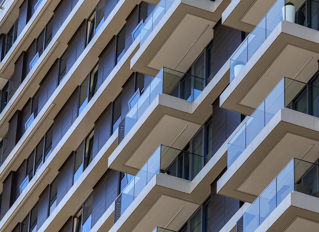 Insuance by Industry - Abstract View of a Modern Apartment Buildings With Many Balconies and Glass Windows